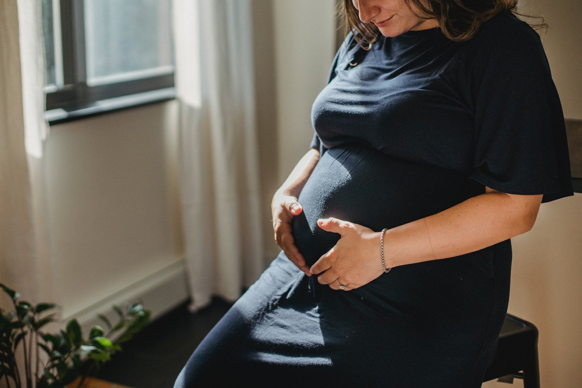 happy pregnant woman holding her stomach