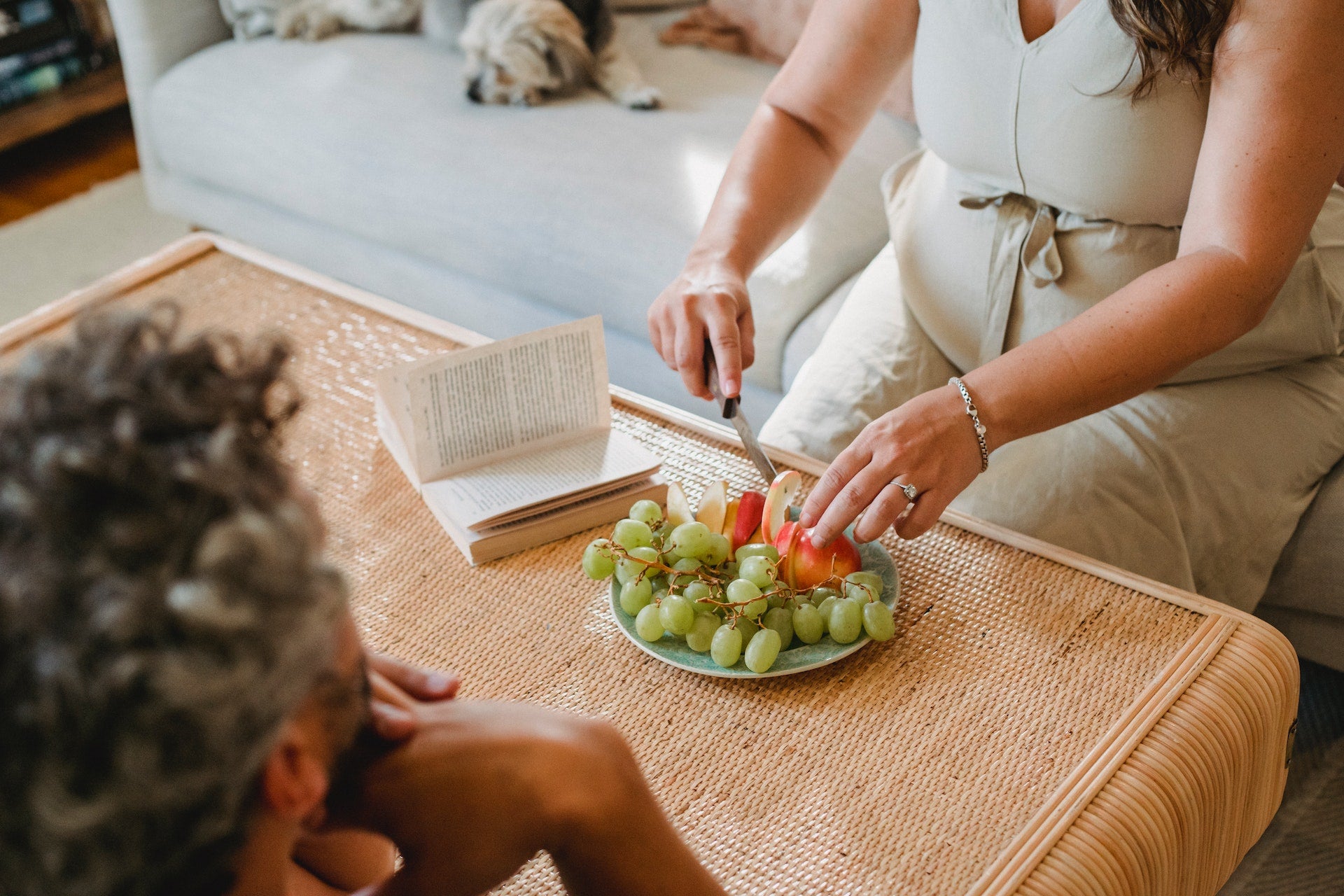 pregnant woman cutting fruit