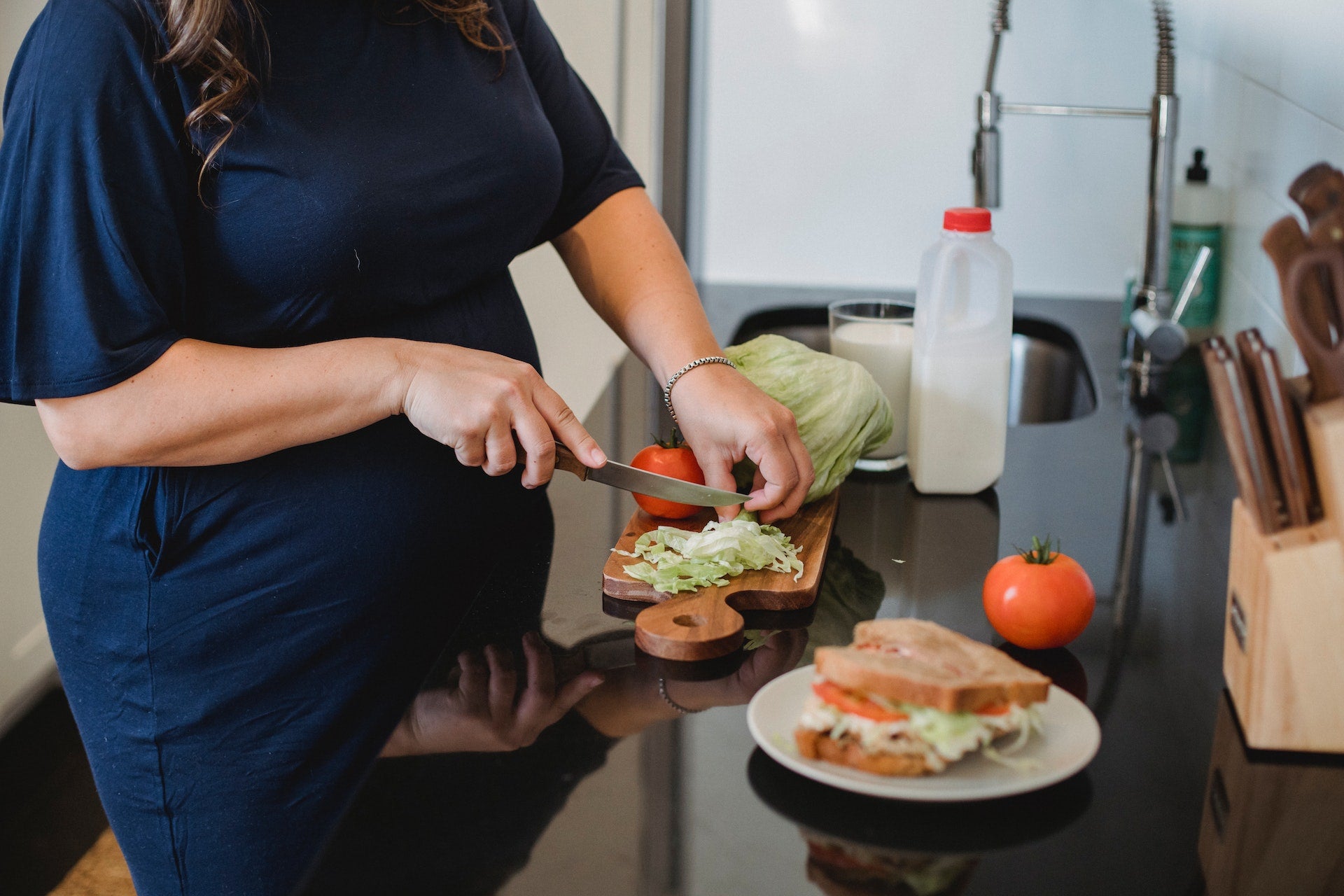 Pregnant lady preparing a sandwich