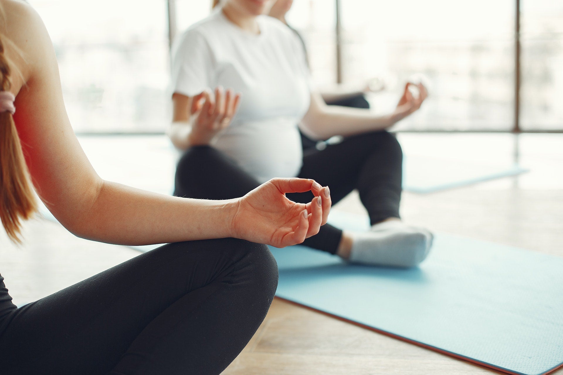 Pregnant woman meditating and doing yoga