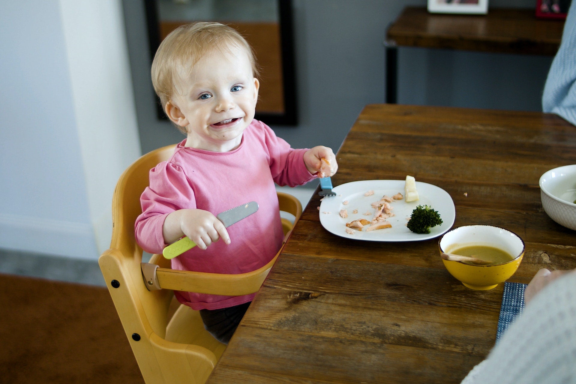 a baby eating from a high chair