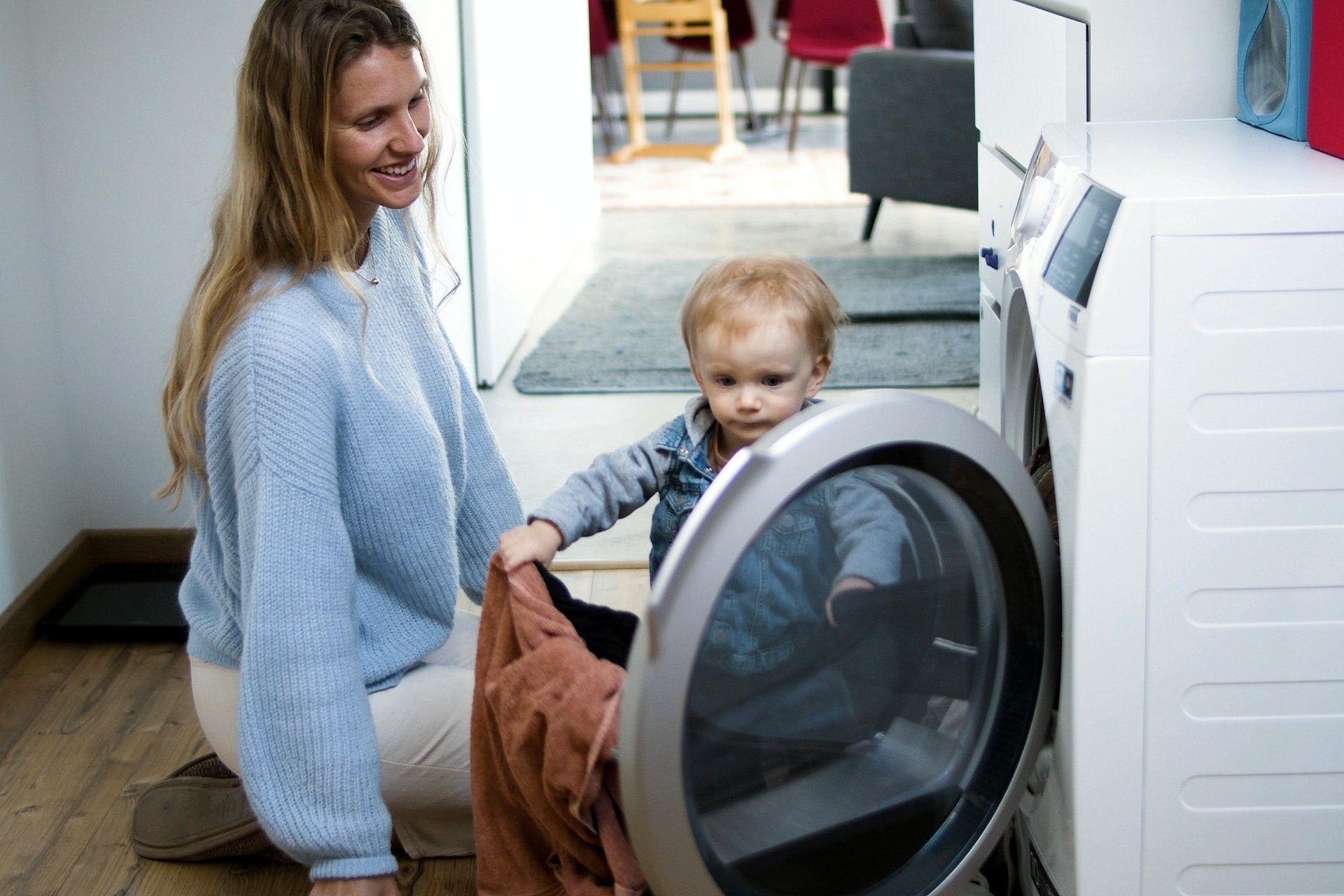 mother doing laundry with her baby