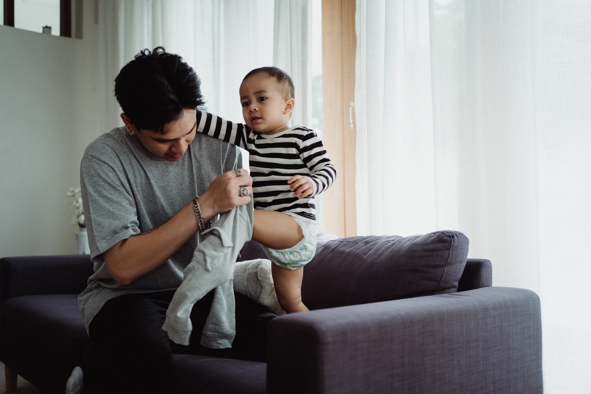 Dad dressing baby