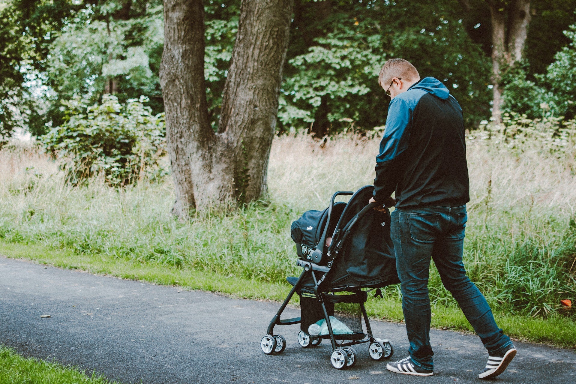 father walking his baby in a stroller