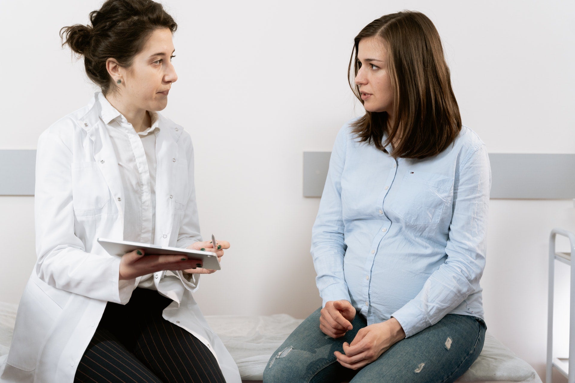 pregnant woman talking to doctor