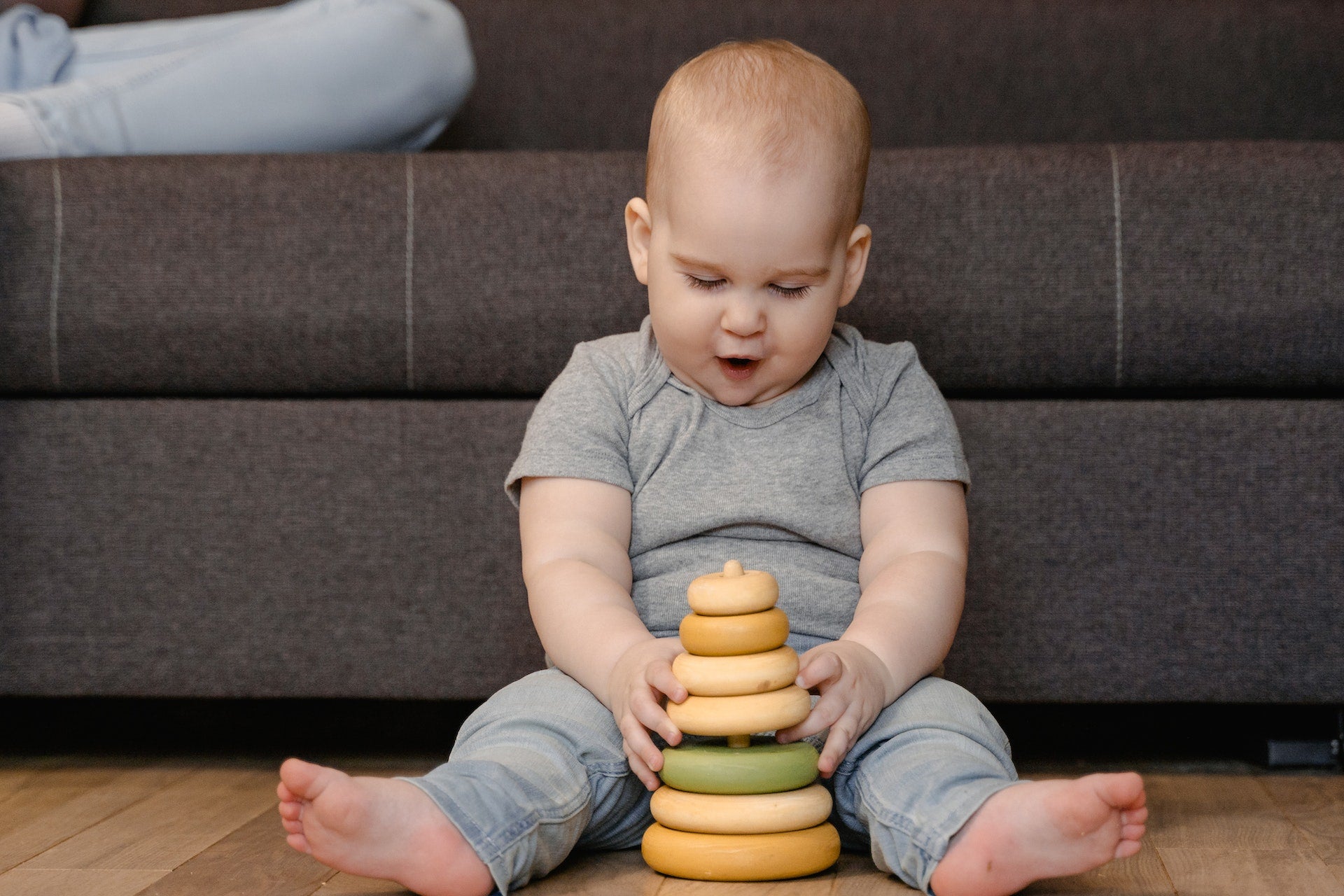 a baby using a stacking toy