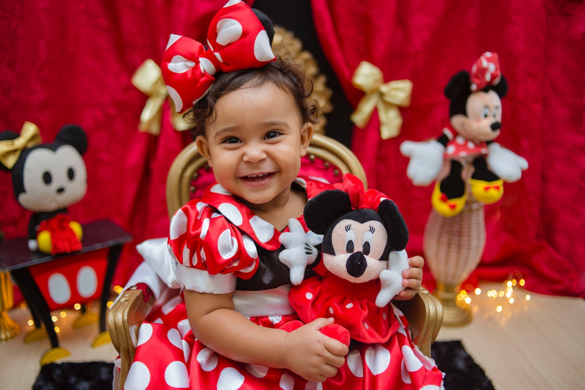 baby holding minnie mouse stuffed animal