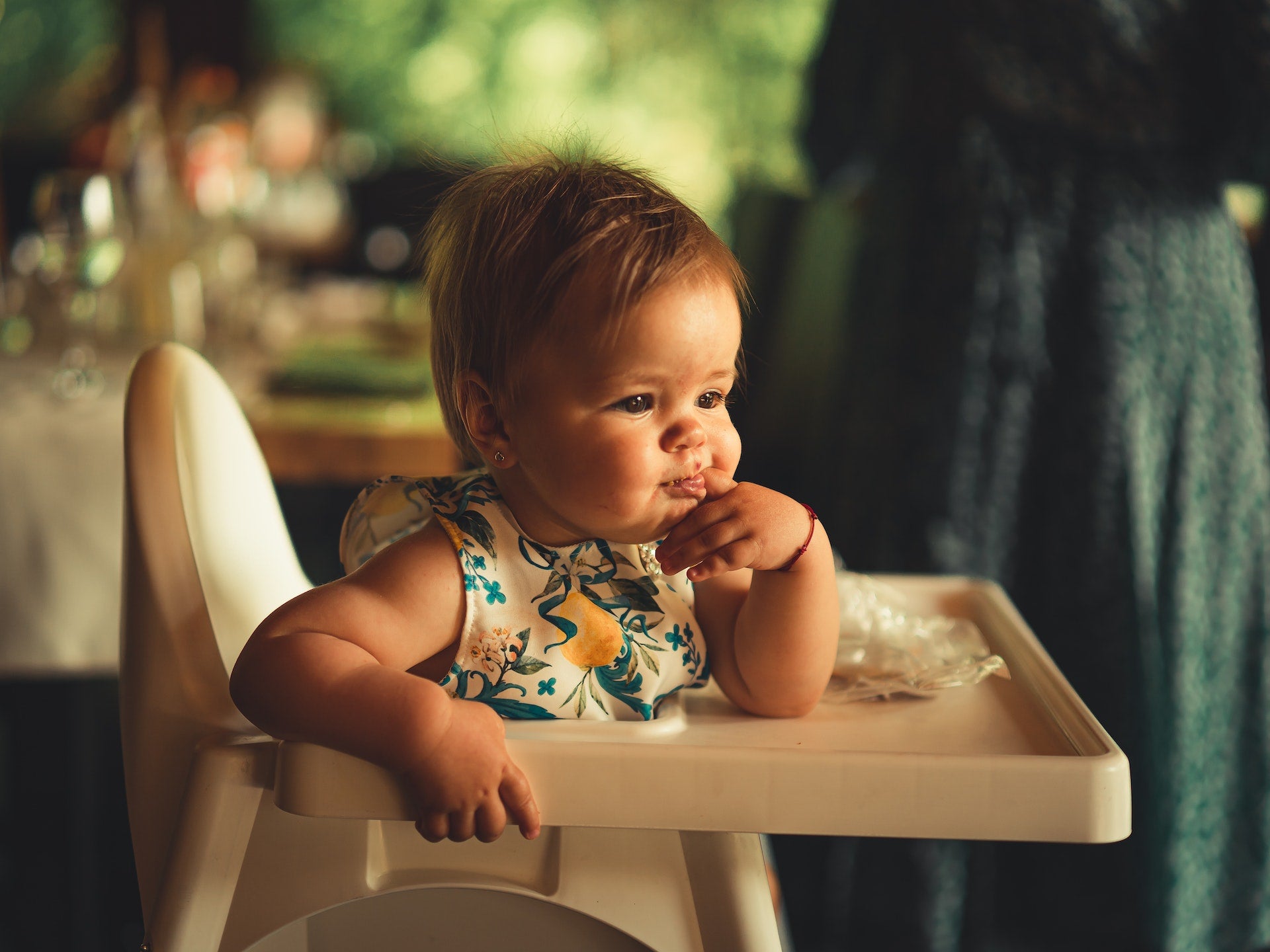 a baby sitting on a high chair