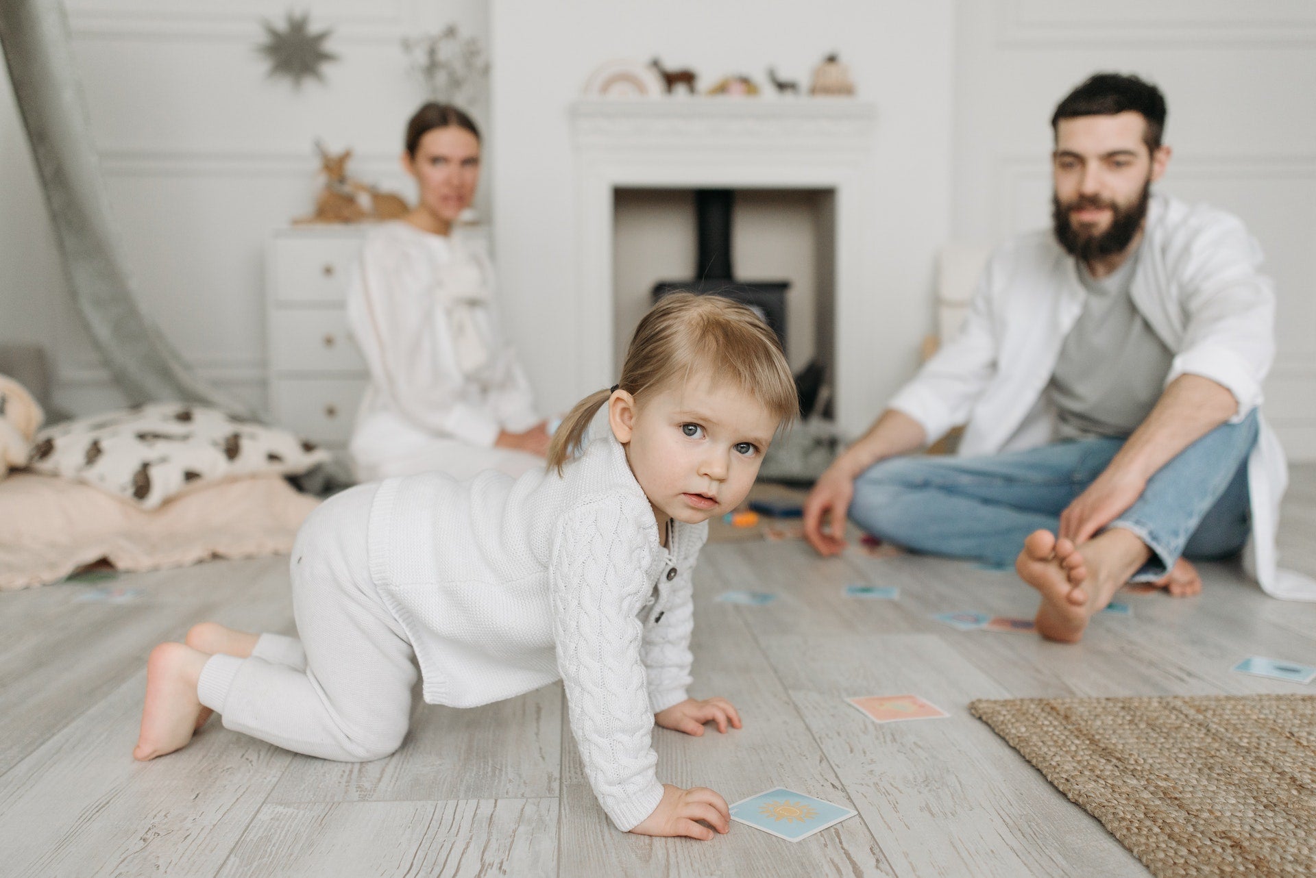 parent with a toddler crawling on the floor