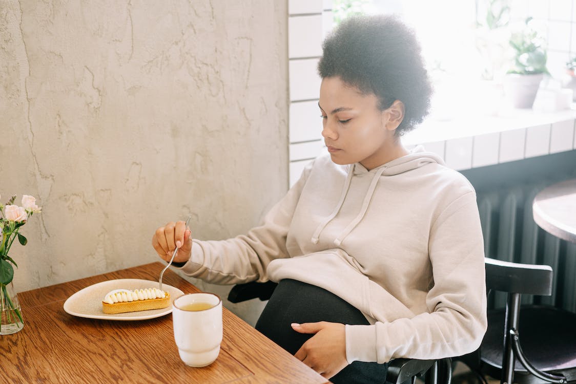 pregnant woman eating a pie