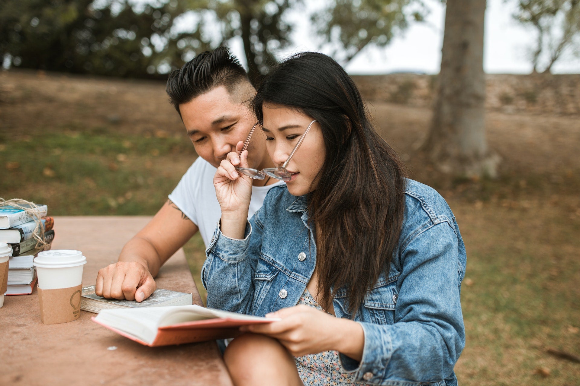 couple smiling and looking at a book