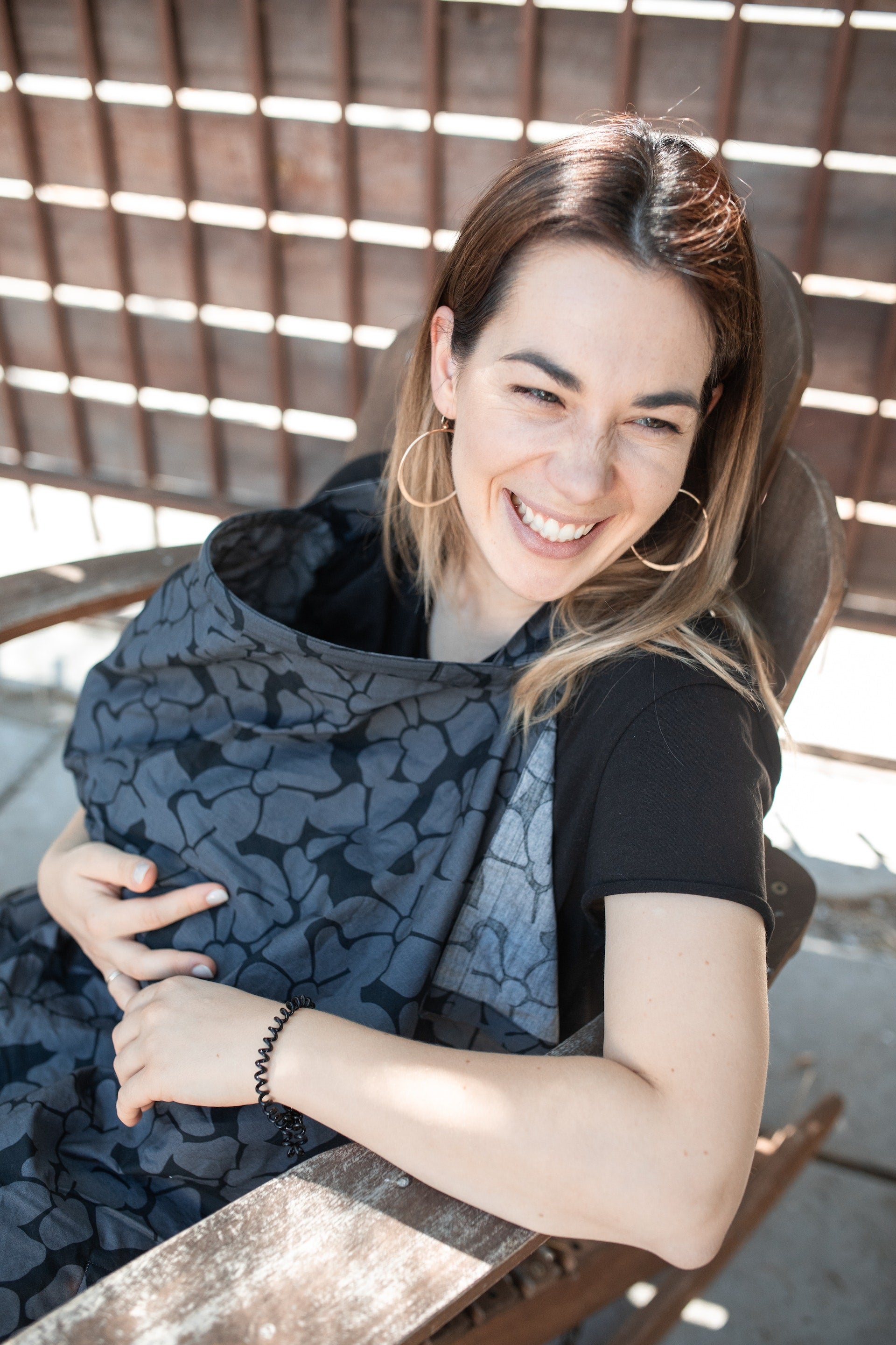 smiling woman with nursing cover