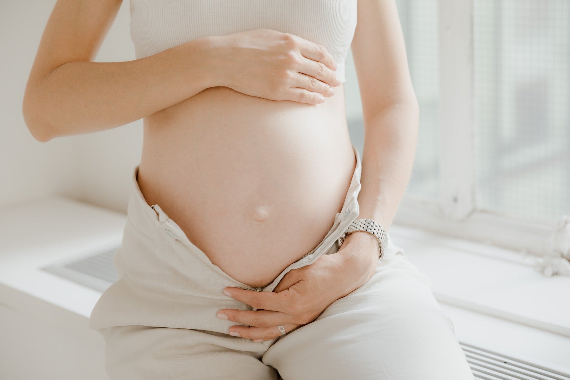 pregnant woman holding her stomach