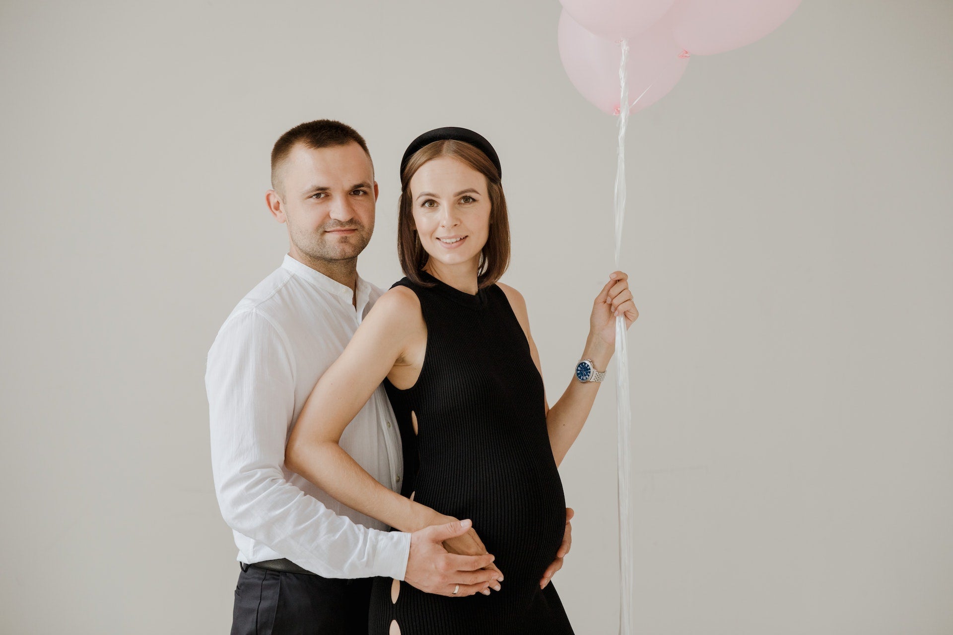 man posing with a pregnant woman