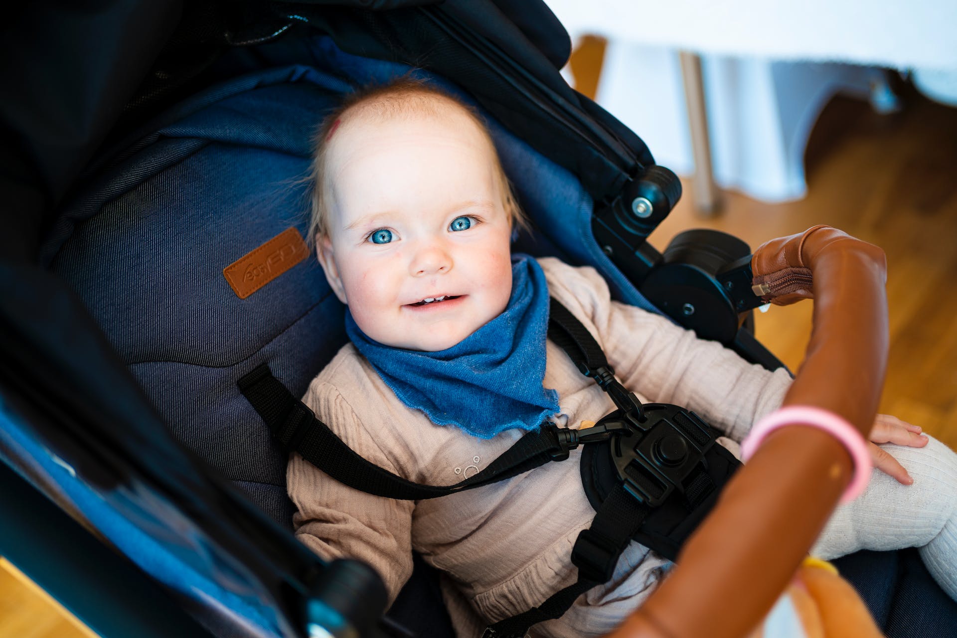 Smiling baby sits in stroller