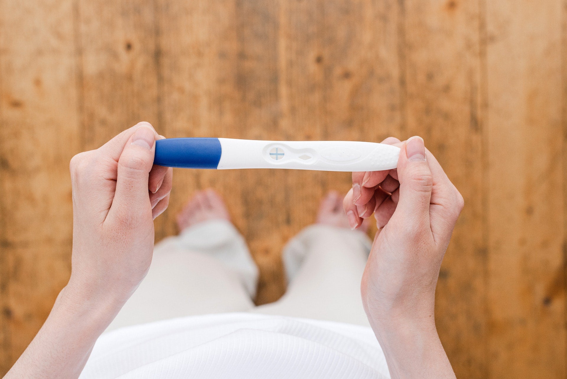 woman holding a pregnancy test