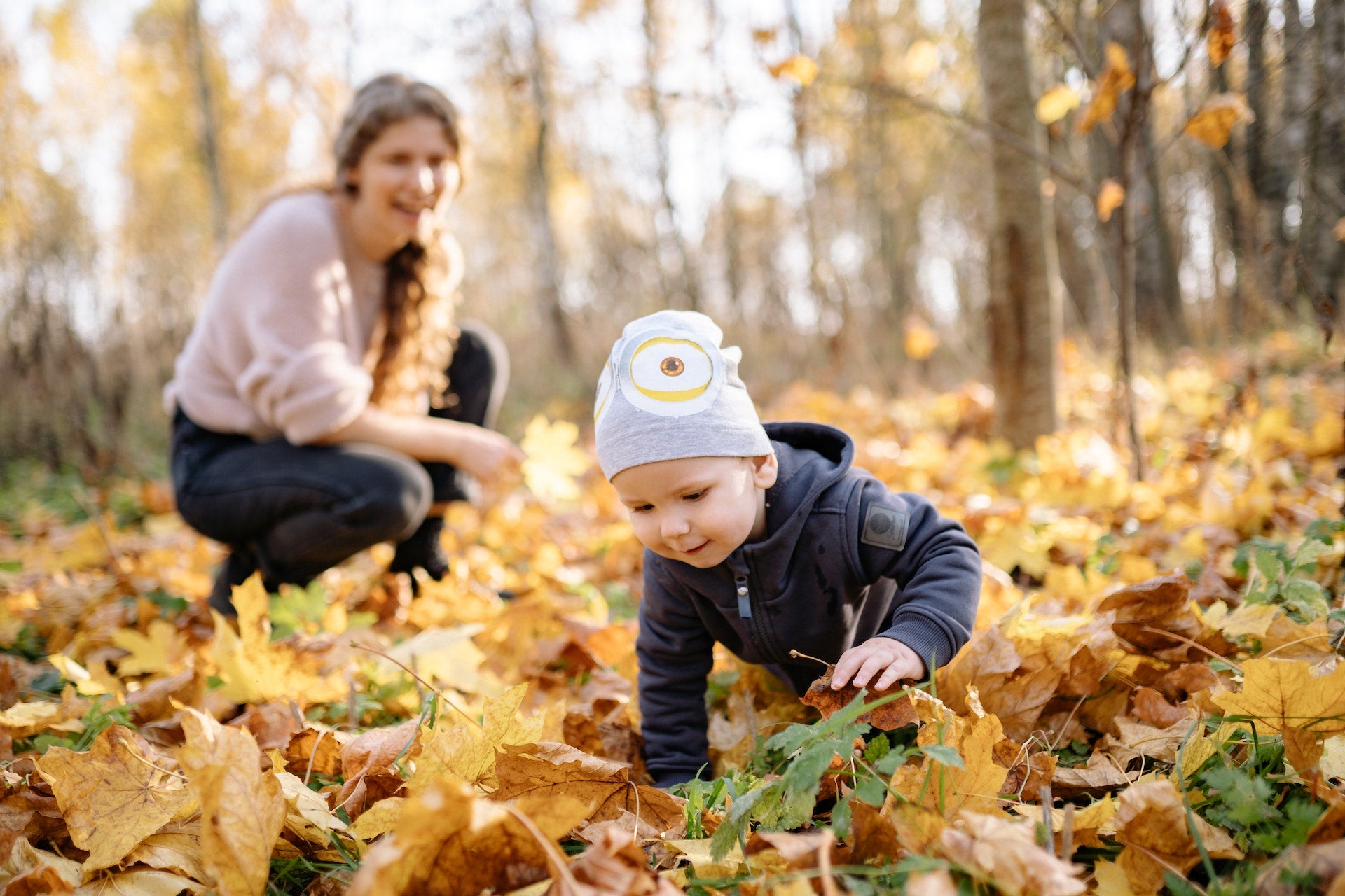 Baby playing with leaves