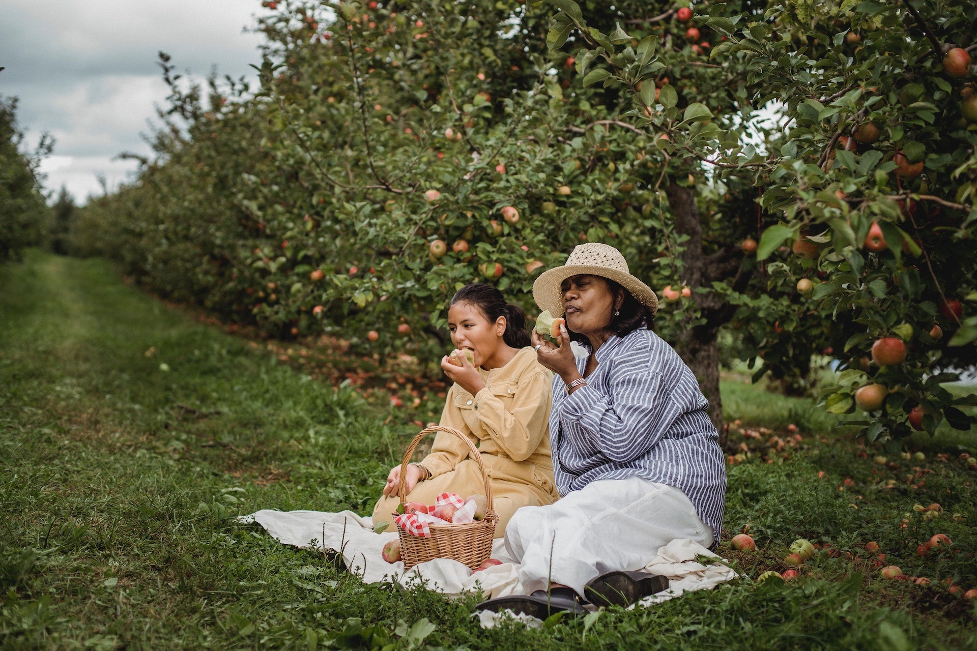 two pregnant women eating outside