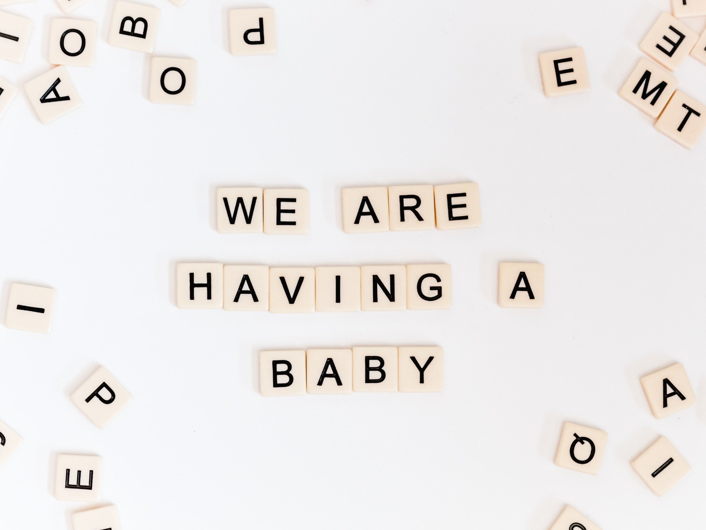 tiles that spell “we are having a baby”