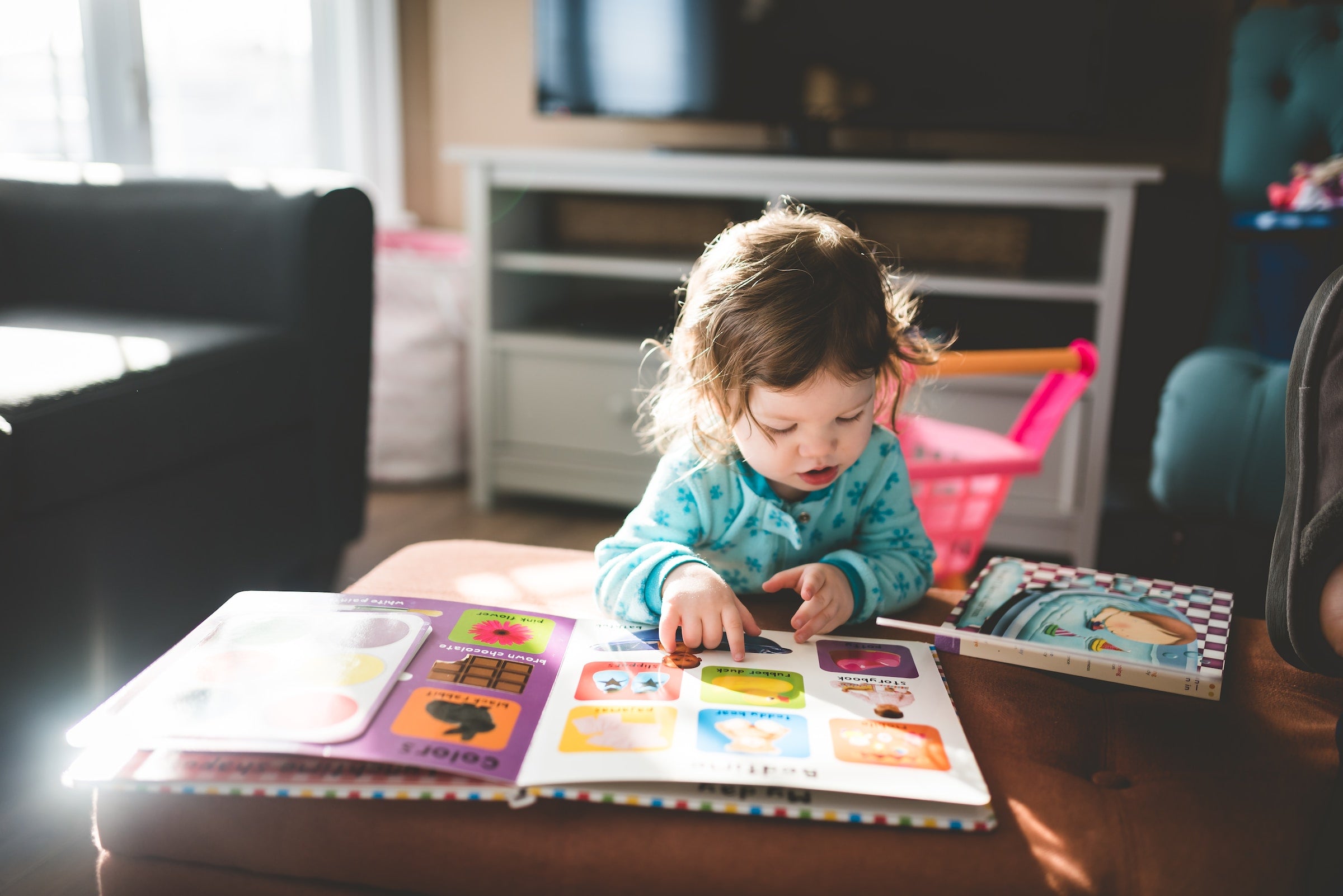 6 month old baby looking at a book