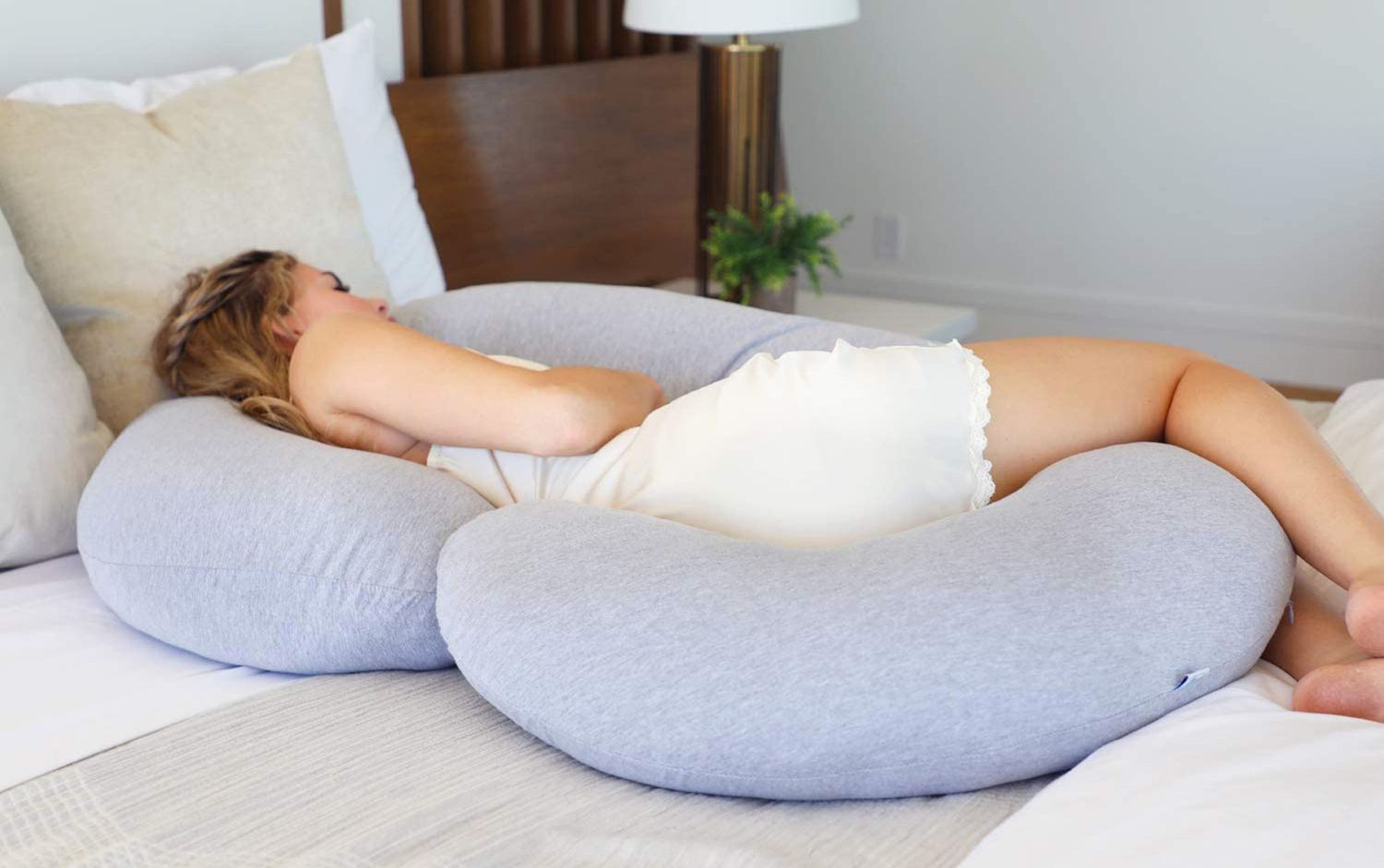 Woman with pregnancy pillow sleeping