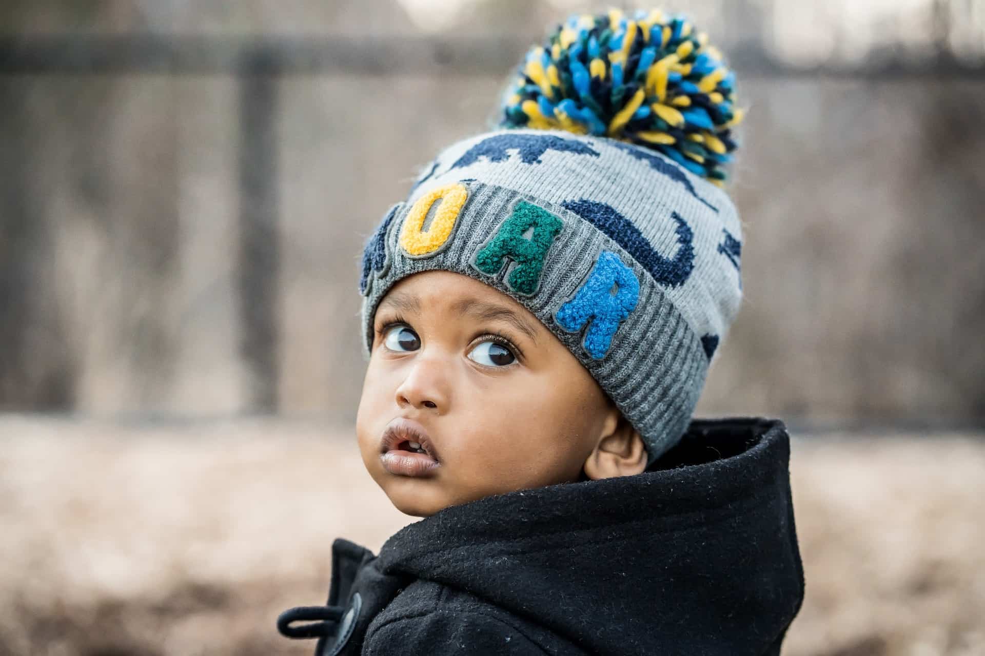 Toddler with a colorful winter hat