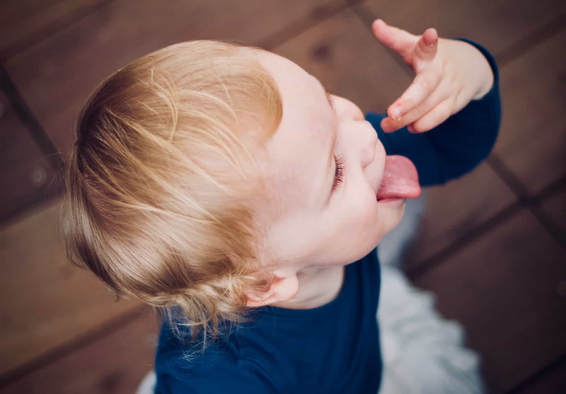 A toddler sticking his tongue out