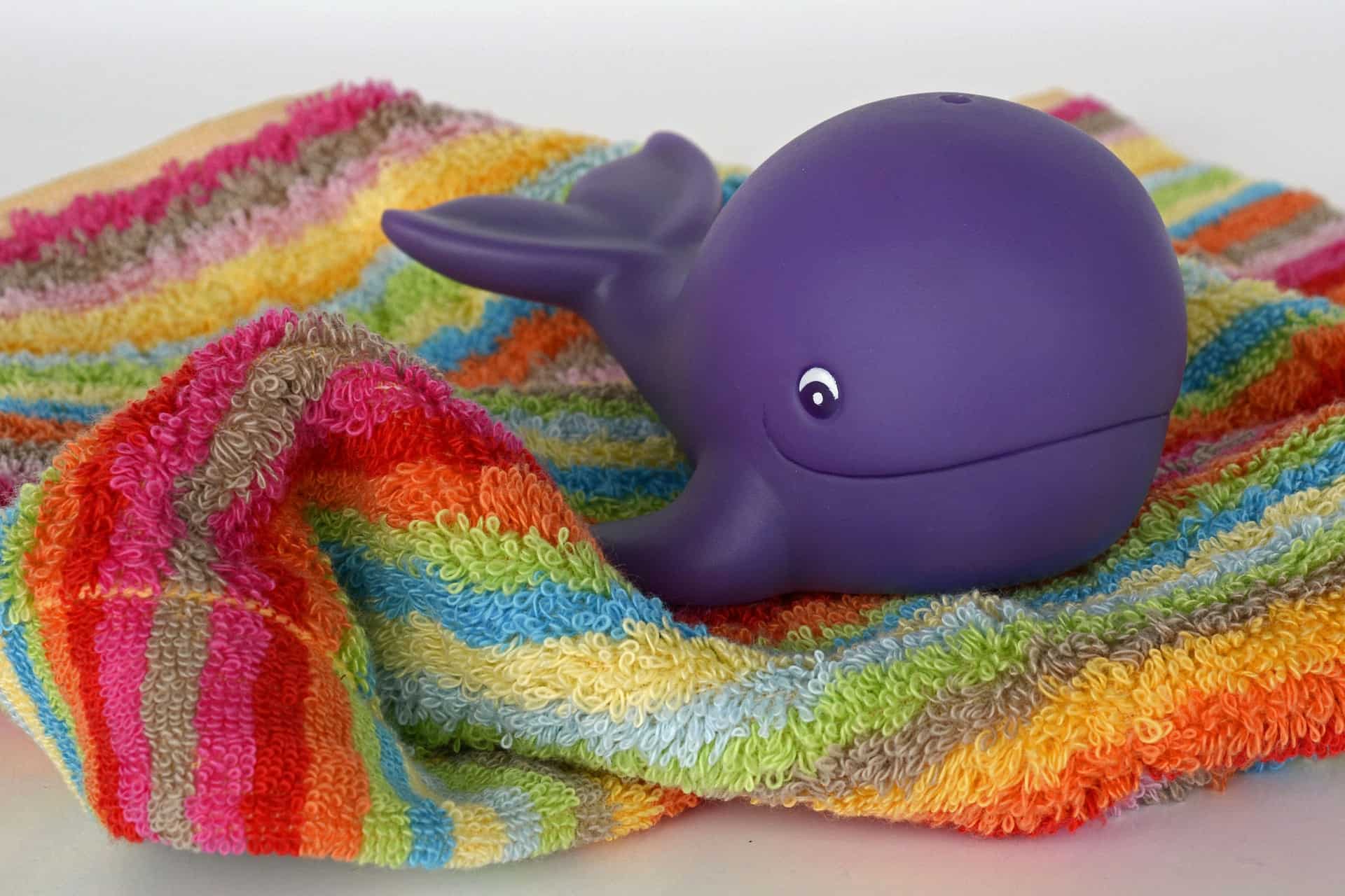 Whale toy on top of colorful towel