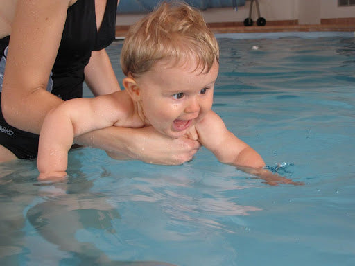 baby splashing at a pool