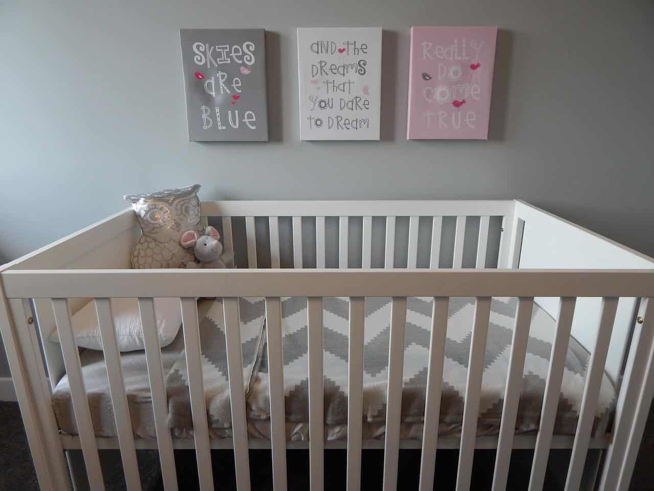 a white wooden crib in a blue baby room