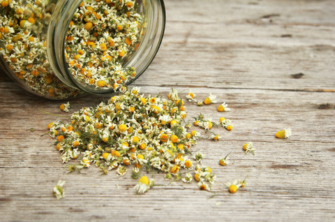 Jar of organic chamomile, a plant with natural anti-anxiety and calming effects.