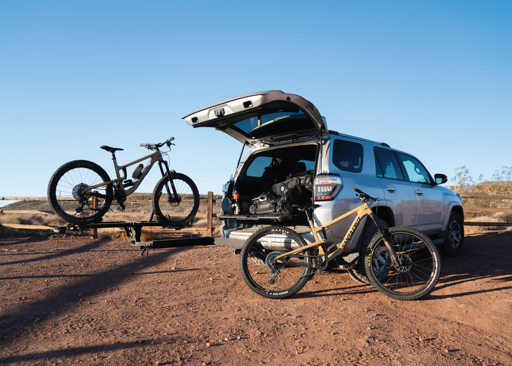 Two bicycles sitting in front of a car