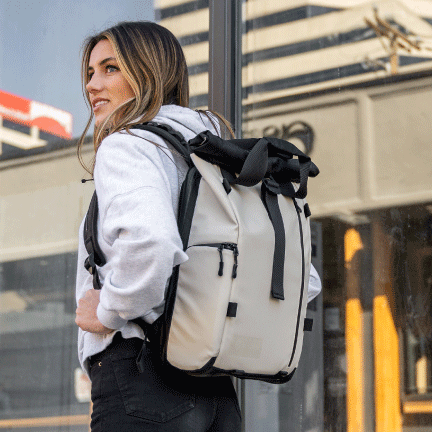 A woman wears the PRVKE Lite in Yuma Tan, walking outside.