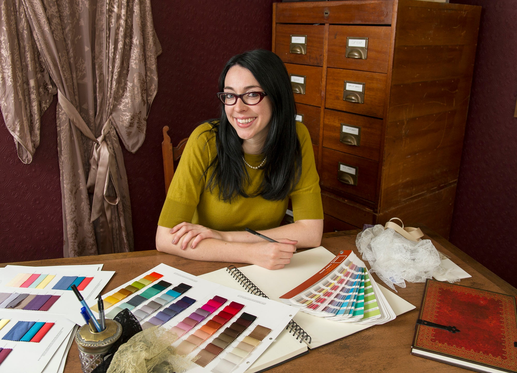 Brand founder with silk swatches and design materials