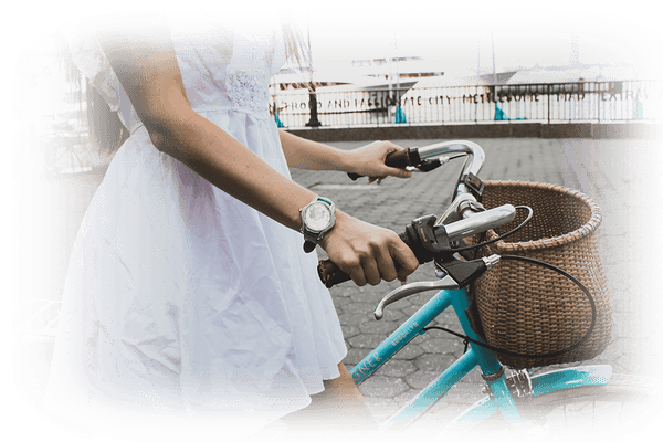 Woman walking and riding her bike with watch on