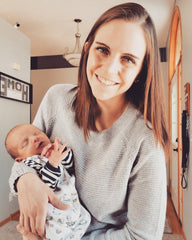 WOman holding baby and smiling