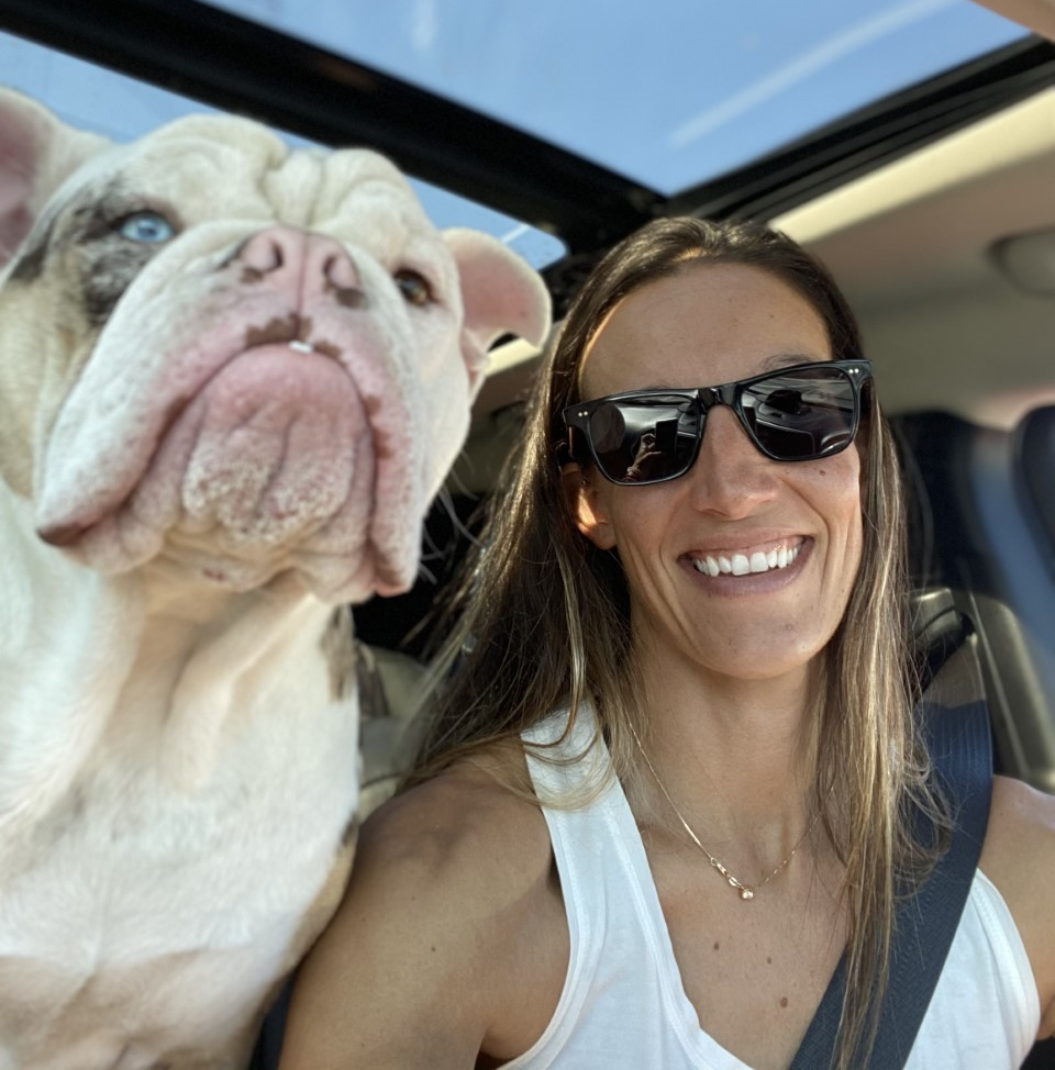 Woman with a dog riding in a car