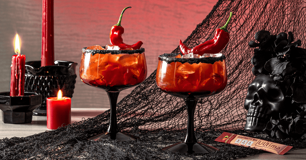 Halloween themed glasses of Devil’s Delight Peach Bellini Sugar-free Cocktails made with Ultima Replenisher