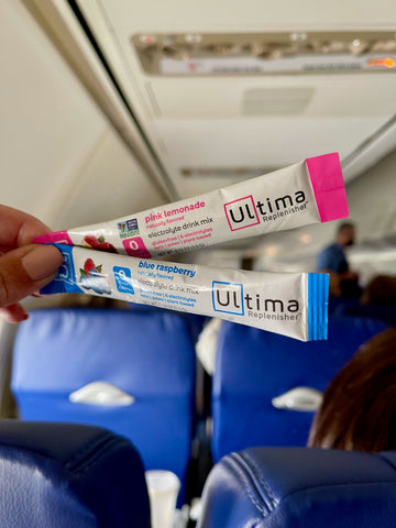 Ultima Replenisher Stickpacks on a plane for travel hydration