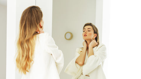 woman in front of mirror long blond hair