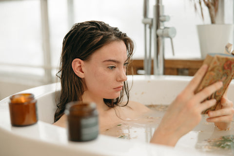 woman reading candle bath