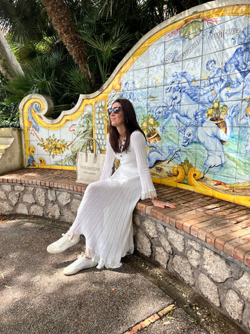 Soru Jewellery Founder Marianna Doyle sitting on the Majolica bench in Capri's Augustus gardens 