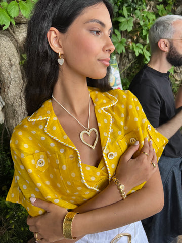 soru capri photoshoot model wearing yellow top and heart necklace