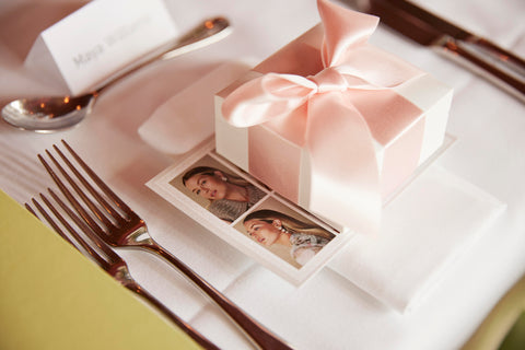 soru gift box wrapped with pink ribbon on a table setting