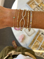 stack of diamond and sapphire bracelets on a wrist