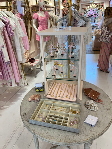 soru jewellery display inside glass cabinet at the love shack fancy store