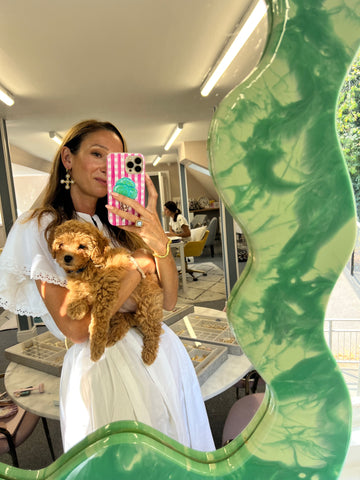 Founder of Soru Jewellery Francesca Kelly standing with maltipoo puppy dog in her office