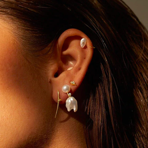 a ear with pearl earrings