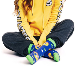model in a hoodie wearing zodiac sign crew socks Capricorn from Tale of Socks