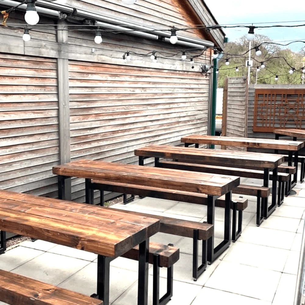 Row of outdoor reclaimed wooden tables